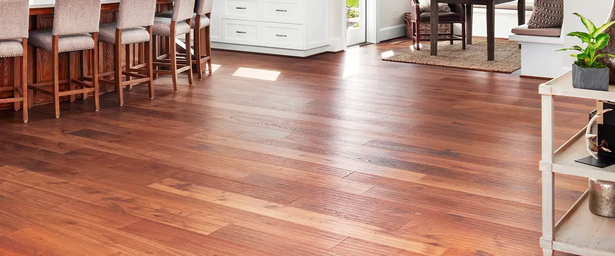 Refinished hardwood floor in a bright, modern dining and living area with natural light