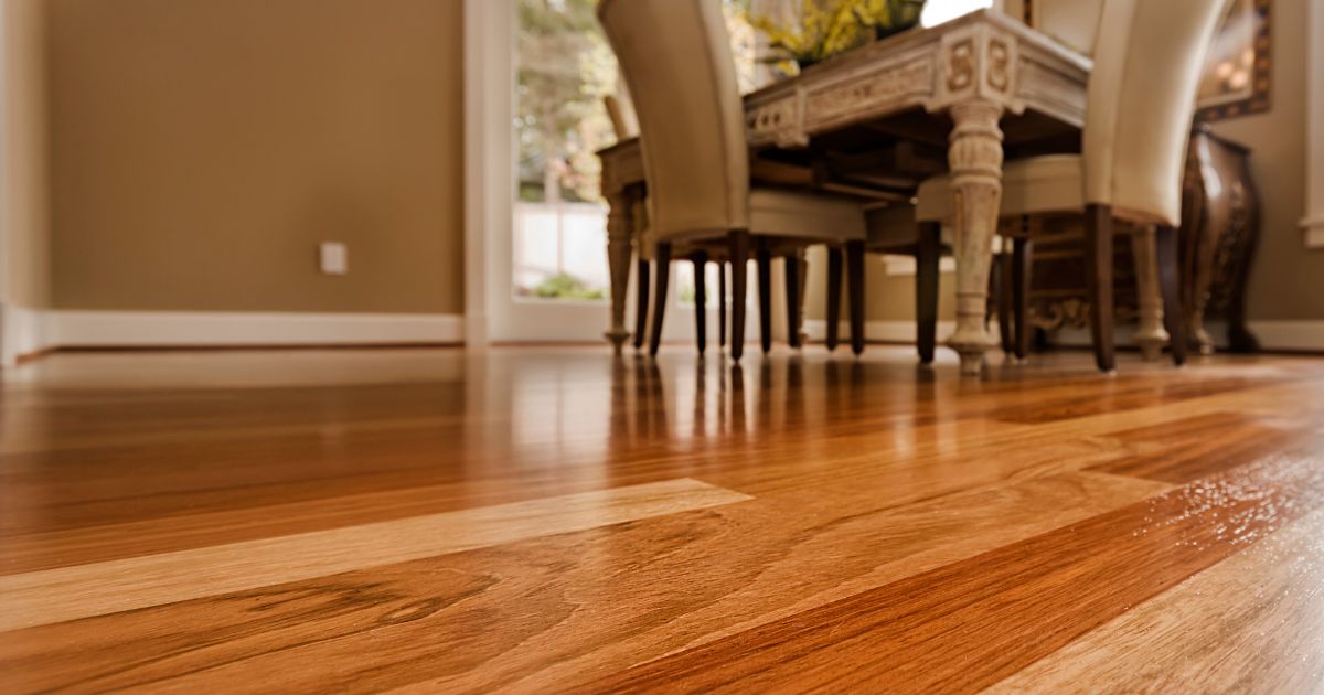 Elegant wooden flooring in a dining area with natural light reflecting off the surface.